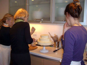 I've said all along I am not a cake decorator, so it was really humbling to be working with Susan Sugarman and having to hold that pastry bag correctly! Fortunately we both worked on the wedding cake. Susan shared a trick - she frosted the wedding cake with my cream cheese frosting but used the canned vanilla frosting for piping on details.