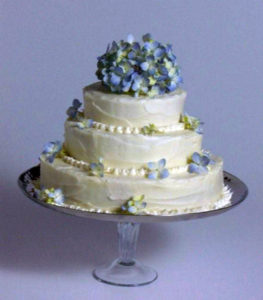 We dashed to Whole Foods at 6 p.m. to buy the blue hydrangeas, then the finished wedding cake went before the camera. Within minutes, our coats were on, lights were turned off, and everyone called it a day. When I saw this photo later it seemed sad because the wedding cake was all dressed up with no place to go except the photo spread in the cookbook...