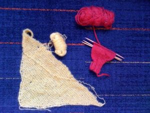 My knitting legacy: One-third of a red mitten and a mysterious yellow triangle (I think it was going to be a capelet).