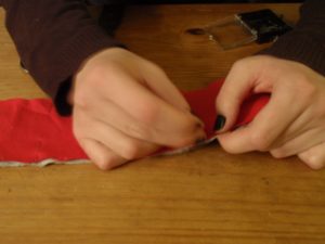 Lay the strips on top of each other, right sides together, and pin them along both edges.